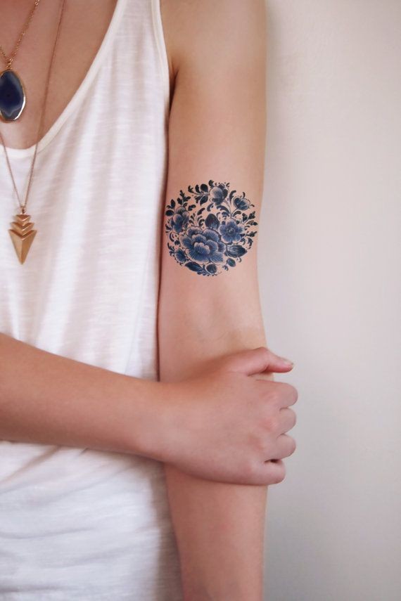 Amasing dark blue flowers tattoo on arm for girls