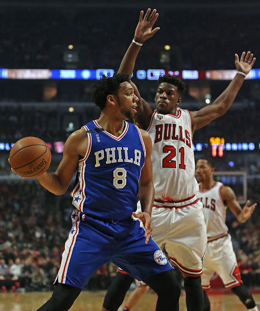 During an active off-season, the Chicago Bulls and the Philadelphia 76ers have been among two of the busiest.  Each team has been working very hard to reshape the very identities of their teams.  Following the introduction of the Chicago Bulls' first round draft pick Denzel Valentine, Chicago Bulls GM Gar Forman told the press that the Chicago Bulls would be actively looking to get "younger and more athletic".   The Chicago Bulls have been aggressively inquiring about a number of players including Philadelphia 76ers Jahlil Okafor. Meanwhile, the Philadelphia 76ers, following the drafting of 2016 #1 Overall Pick Ben Simmons, have been adding veterans in order to fill out what they envision as a playoff ready roster around Simmons.  So, it was pretty easy to predict that several early off-season trade rumors suggested that the Chicago Bulls, a team flush with playoff-tested veterans, and the young Philadelphia 76ers were close to a deal.  One such rumor had the Chicago Bulls sending Derrick Rose to the 76ers for Nerlens Noel, but now that Rose has already been shipped off to the New York Knicks, the trade rumor that has taken hold has centered around Jahlil Okafor.  The Chicago Bulls, who have been actively pursuing trades, including a potential deal for Russell Westbrook, are reportedly offering Doug McDermott and 2016 First Round Pick Denzel Valentine in exchange for Jahlil Okafor.  The move would not be without risk. The 2015 #3 Overall Pick, Okafor, has had a rookie campaign marred by legal trouble. The talented first year player spent much of his rookie season in trouble with the law nearly as often as making his mark on the court.  In early October of last year, Okafor was involved in an "argument" outside of a Philadelphia nightclub involving a brandished gun.  Then on October 19th of last year, there was an incident on the Benjamin Franklin Bridge where the 6' 11" rookie forward was allegedly going 108 mph.  Then on November 26th, he was captured on video involved in an altercation outside a Boston nightclub although it is unclear whether he was the assailant. Predictably, the video was posted online.  Following the series of incidents, Jahlil Okafor made a very public apology in an effort to rehab his damaged image, in which he promised to maintain his focus on basketball.  Okafor finished his rookie season with impressive numbers (although for a historically bad 76ers team): 17.5 PPG, 7.0 RPG, 1.2 APG, and 1.2 BPG.  Okafor is a Chicago-native who was the top high school recruit in the nation his senior year in high school, who eventually decided to attend Duke University. In his single one-and-done year, he helped lead Duke to the NCAA Championship.  A return home to Chicago might greatly beneficial to Okafor, who built and maintained habits which lead to his most successful years.  In addition, with several strong veteran personalities (Butler, Wade, Rondo, etc.), Okafor may just end up in a situation that could help reduce off-court issues and help his game to flourish.  Would you like to see the Chicago Bulls make a deal with the 76ers to acquire Jahlil Okafor? Would you do this trade? Tell us what you think in the comments below!