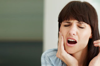 A woman suffering from tooth pain