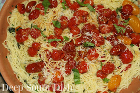 My interpretation of Aglio e Olio, spaghetti, sauteed in olive oil and garlic, tossed with fresh herbs, red pepper flakes and parmesan cheese, and finished with melted tiny tomatoes.