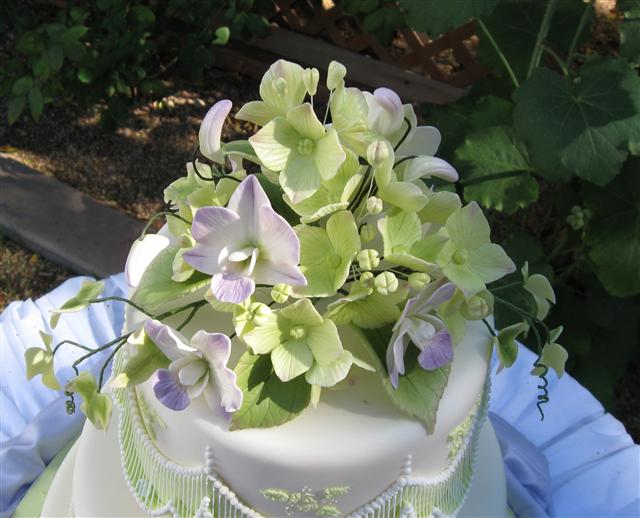 Sugar orchids hydrangeas and ivy wedding cake topper
