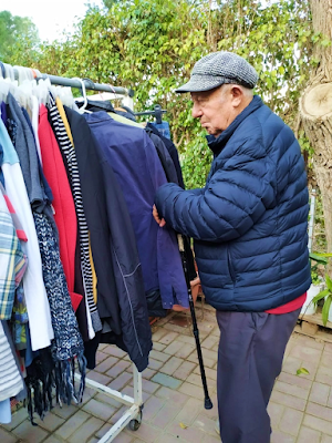Israeli man picking out clothing at Beer Sheva Aid Center