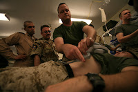 Cmdr. Kevin D. Buckley demonstrates the use of a portable ultrasound device to visiting Iraqi medical officers from Camp Habbaniyah