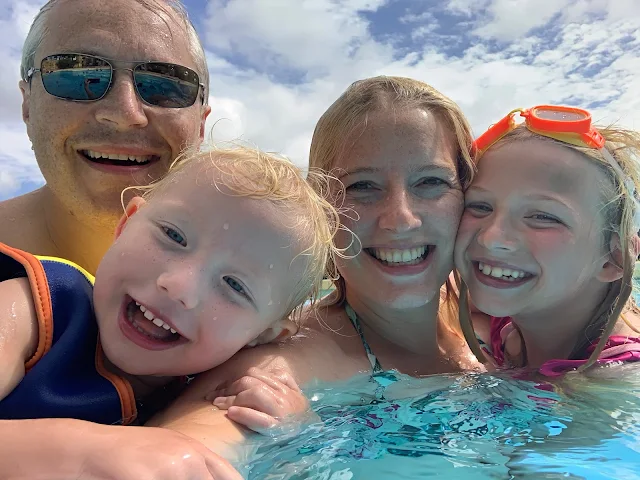 A family selfie in the swimming pool (parents and 2 children)