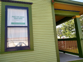 Older building with green siding and porch