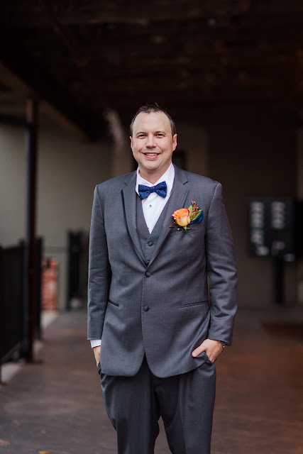 Andy, the groom, looking dashing in his grey 3-piece suit with a blue bowtie and a yellow rose boutonniere.  Set at the Hall at the Railhouse located in Norman, OK during the fall of 2016.