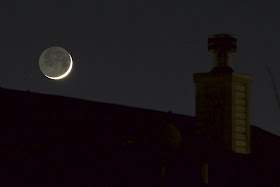 crescent moon over roof