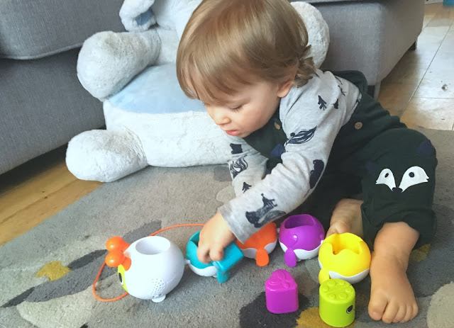 toddler boy playing with the singing sorter by little tikes