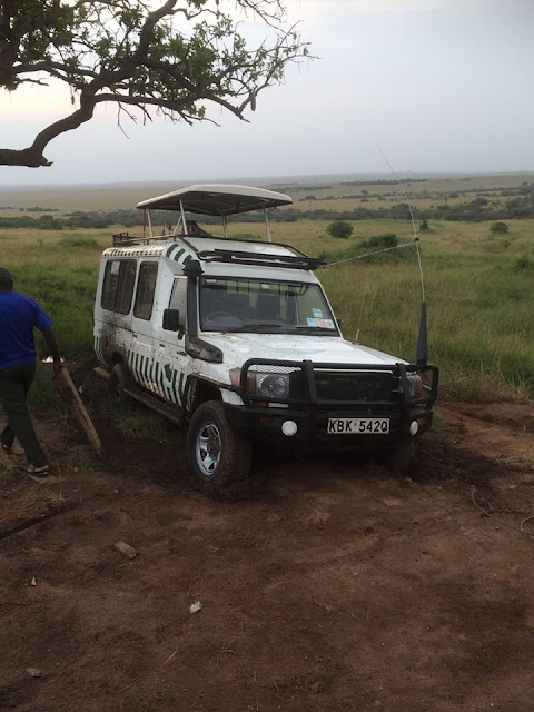 safari vehicle wedged in a ditch masai mara