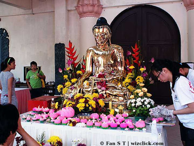 A golden Buddha statue at the front of Asokan hall