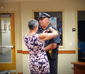 Officer Fiorio getting his badge #1 pinned by his wife