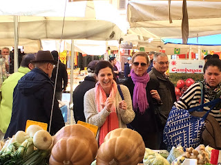 Buying produce from the market vendor stalls in Campo de' Fiori, Rome, Italy