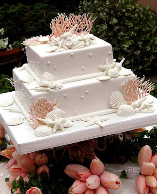 white wadding cake with shell and pearls