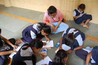 volunteer teaching students to paint 