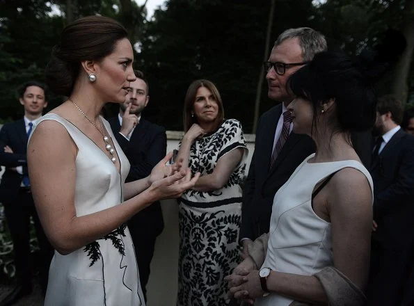 Kate Middleton wore Gosia Baczynska dress and Balenciaga earrings. Kate Middleton carried PRADA Satin Clutch