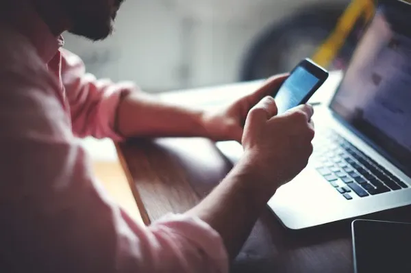 office man holding his smartphone