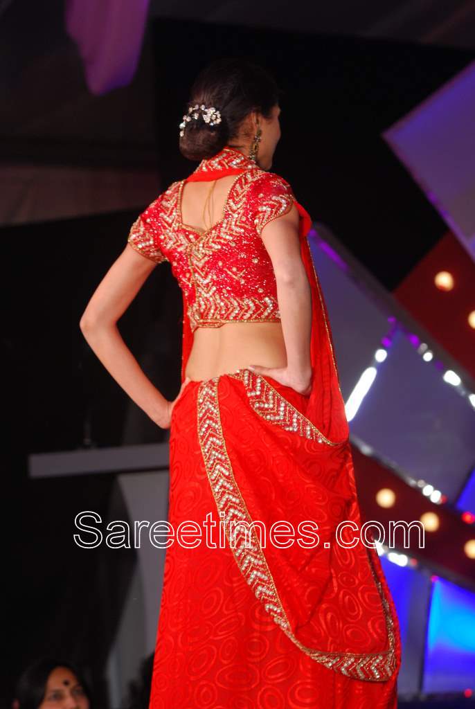 Model displaying beautiful red and embroidered designer saree blouse at 