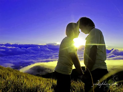 Two lovers romantically enjoying the peak of Mt. pulag with sunrise