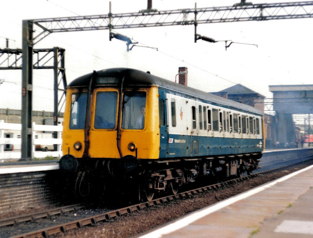 Single-car British Rail Bubble Car DMU 55011 leaving Bletchley station in a plume of diesel exhaust fumes in the late 1980's