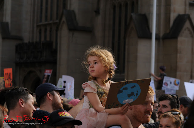 Sydney Climate Rally - it is all about saving the planet for future generations - Girl on parents shoulder holding save the planet sign.