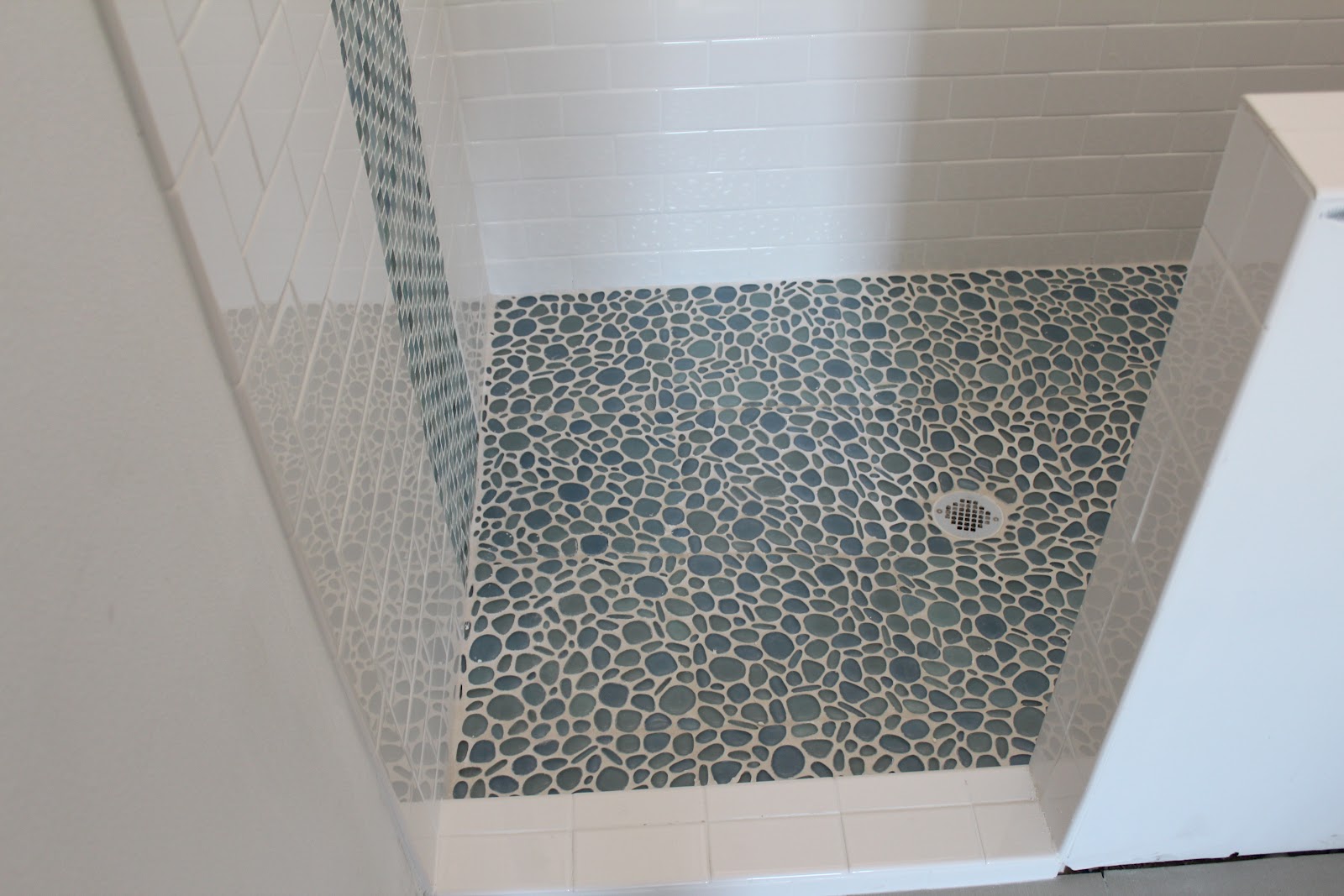 bathroom glass shower Love the glass river rock and the vertical run of the glass mosaic 