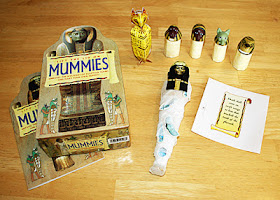 Our completed mummy, canopic jars and cat coffin. Tessa and I stuck the amulet stickers onto cardboard remnants left over from the canopic jars and then I cut around them so she can play with them again and again.