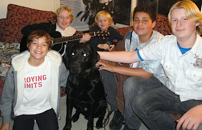 A village of Foster Care Providers with a black Lab