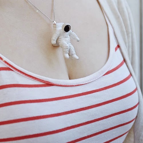 The necklaces shaped a man skiing on women's cleavage The necklaces shaped a man skiing on women's cleavage