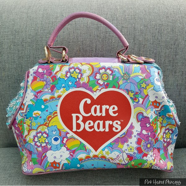 printed brightly coloured Care Bear bag back with large heart logo