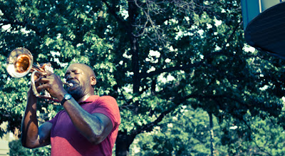 Man playing trumpet at Woodley Park metro stop in Washington, DC.