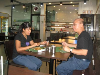 couple enjoying their banana leaf rice at Kashmir Cafes