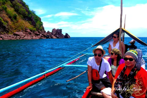 Backpackers enjoying a boat ride circling the Bellarocca island 