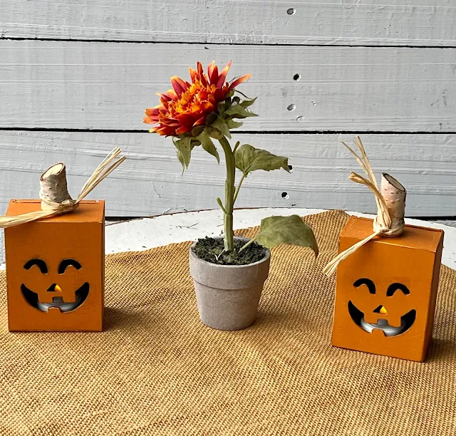 Photo of Dollar Tree painted/upcycled Jack O' Lantern boxes with tealight LED candles.