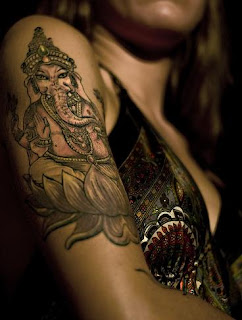 Ganesha Tattoo on up arm of girl