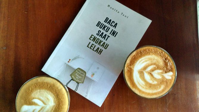 Membaca buku di kedai kopi