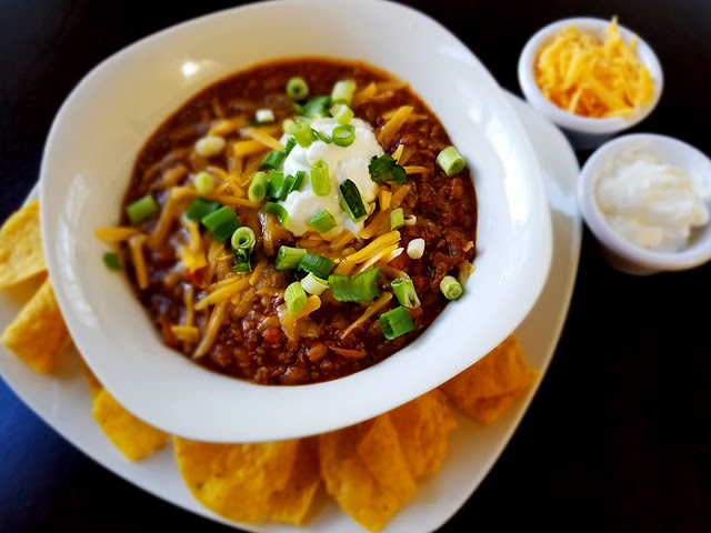 Instant Pot vegan chipotle chili with chips, cheese, and sour cream