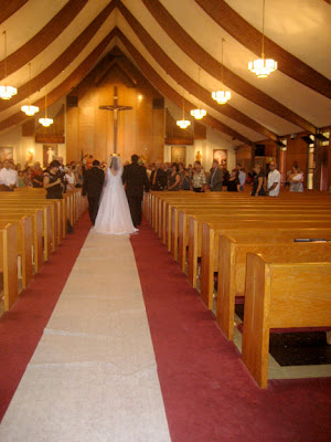 Here Lea carries her veil and train into the church