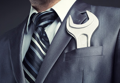 Man has a wrench in his suit pocket