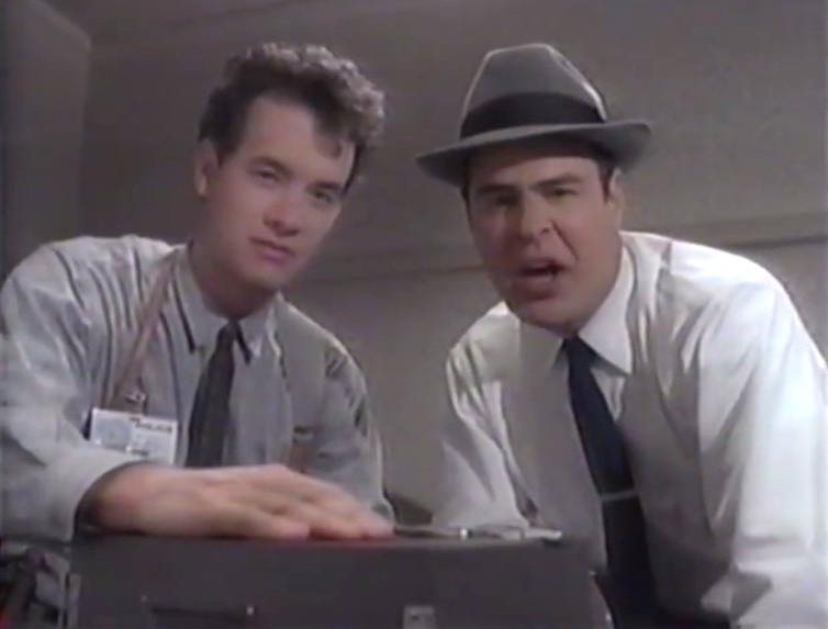 Tom Hanks and Dan Aykroyd as police detectives looking into camera