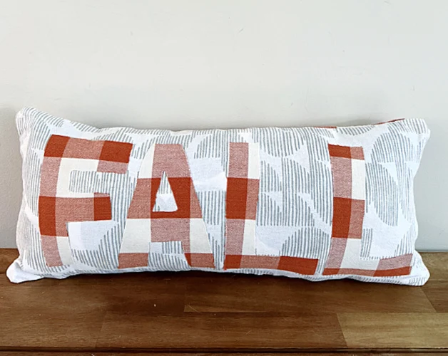 stuffed fall pillow on a bench