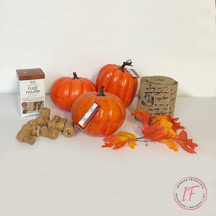 How to turn plastic dollar store pumpkins into unique French script burlap decoupage pumpkins with faux rusted iron leaves and fun wine cork stems.