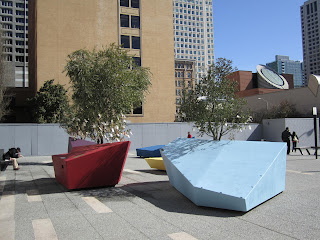 a photo of the front courtyard of San Francisco's Contemporary Jewish Museum, with trees whose branches have papers hanging from them.