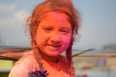cute coloured girl having fun in holi celebration