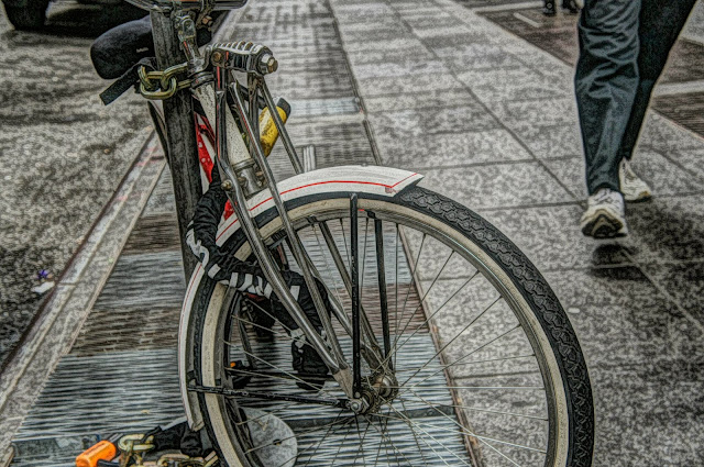 bicycle tied on a pole 