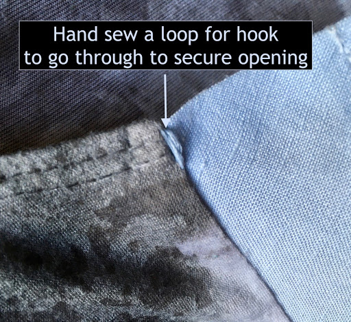Picture of hand sew loop at top center opening of lightweight jacket for hook to go through and attach.