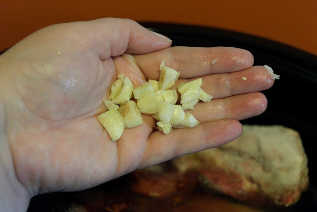 A palm full of roughly chopped garlic.