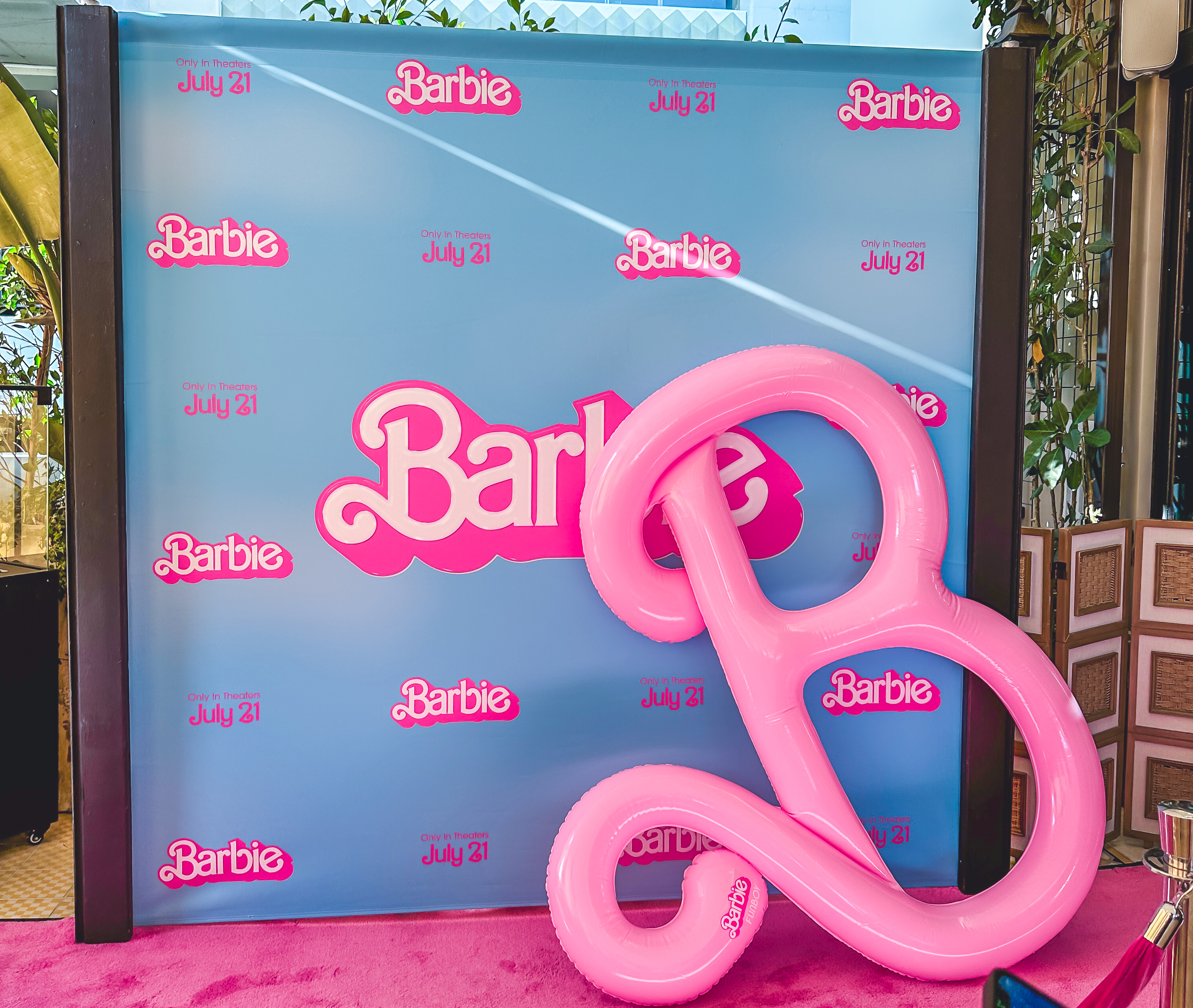 Blue Barbie backdrop with Barbie logos and a giant inflatable Barbie letter B