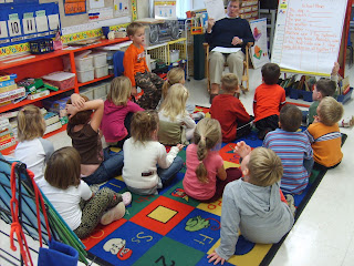 Classroom with kids and teacher sitting around together