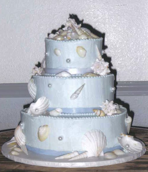 Metallic light blue beach wedding cake with white seashells and light blue 