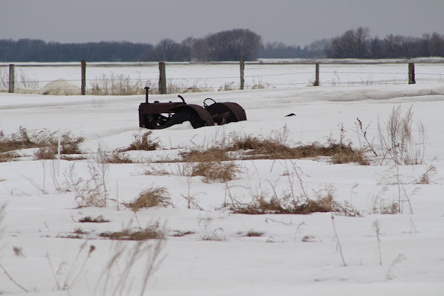 An old tractor buried in the snow